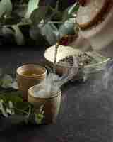 Free photo close-up teacup pouring tea