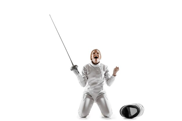 Close up of teen girl in fencing costume with sword in hand isolated on white studio background.