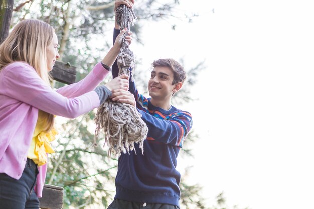 Close-up of teenagers holding a rope