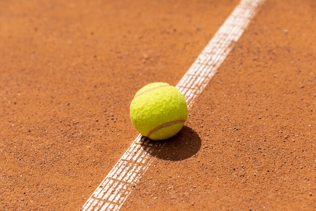 Close-up tennis ball on court ground