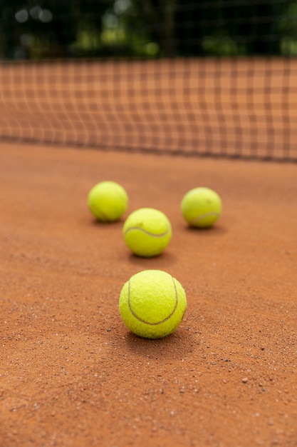 Close-up tennis balls on court ground