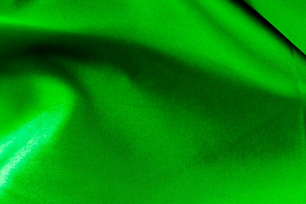 Крупный план текстуры зеленой ткани костюма