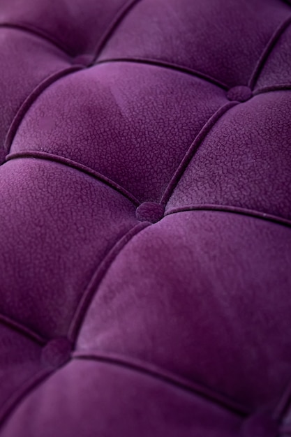 Close up textured purple velvet fabric modern sofa with sunken buttons. Idea and variant of fabric for upholstery sofa.