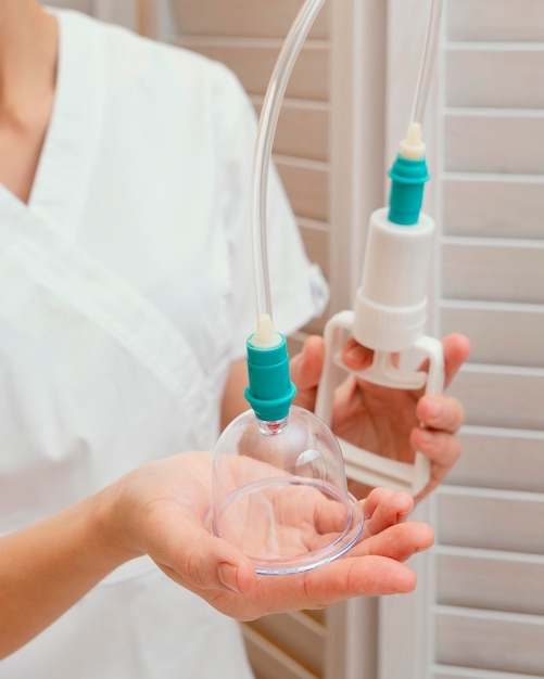 Close up therapist holding cupping tool