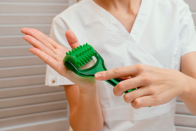 Close up therapist holding tool