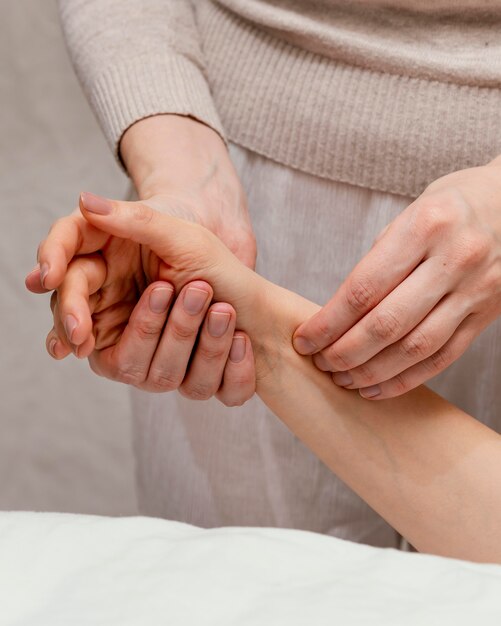 Close up therapist massaging arm