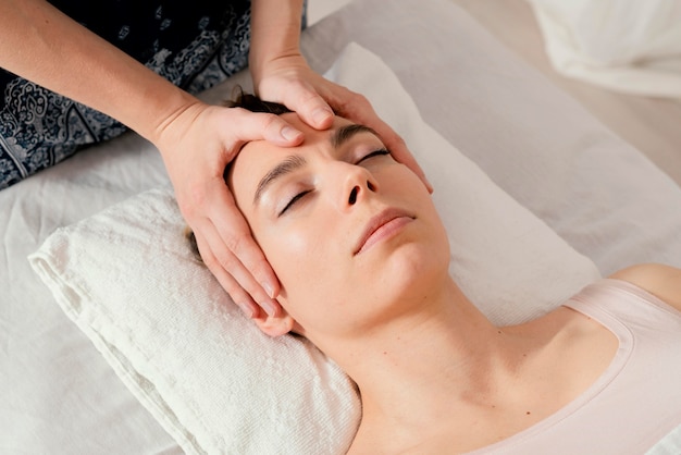 Close up therapist massaging patient's head