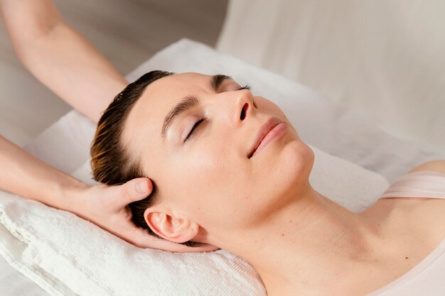 Close up therapist massaging patient's scalp