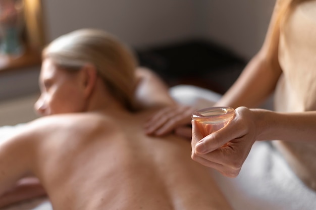 Close-up therapist massaging woman