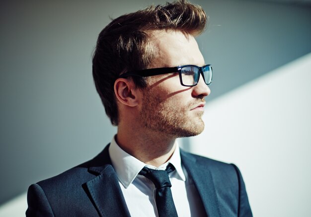 Close-up of thoughtful businessman with glasses