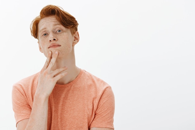 Close-up of thoughtful handsome redhead man, student making decision, choosing