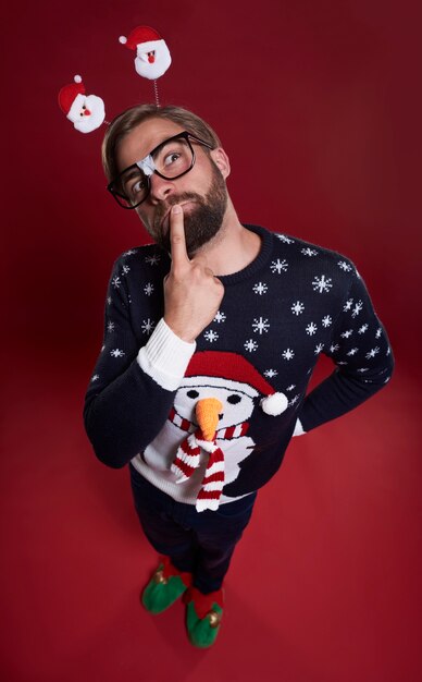 Close up of thoughtful man dressed in Christmas clothes