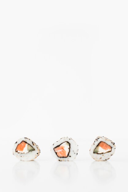 Close-up of three sushi against white background