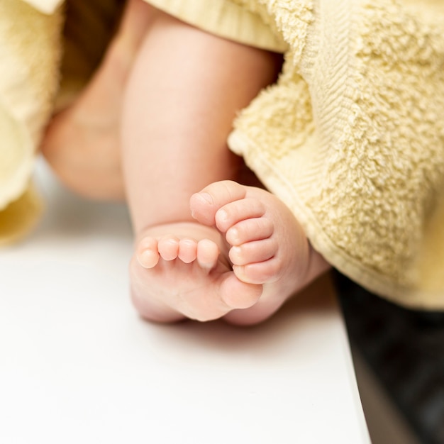 Close-up tiny baby feet with towel