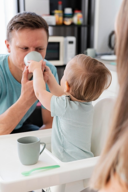 Close up toddler feeding father