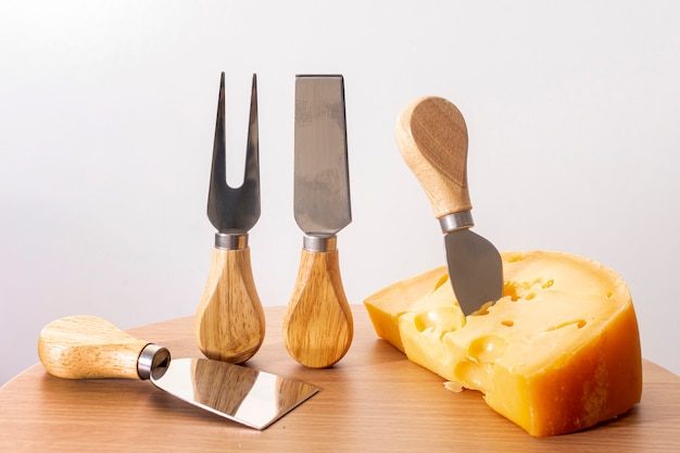 Close-up tools with slice of cheese on a table