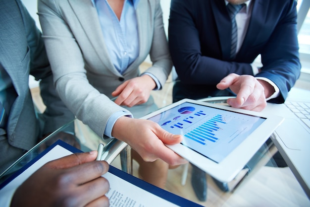 Close-up of touchpad in executive hands during meeting Free Photo