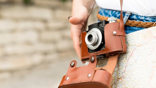 Close-up tourist with photo camera