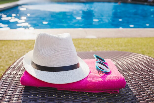 Close-up of towel, sunglasses and hat