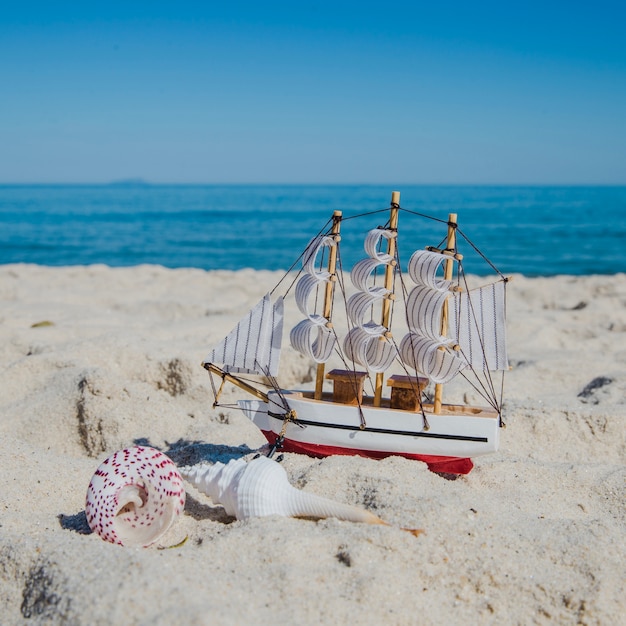 Close-up of toy ship on sand