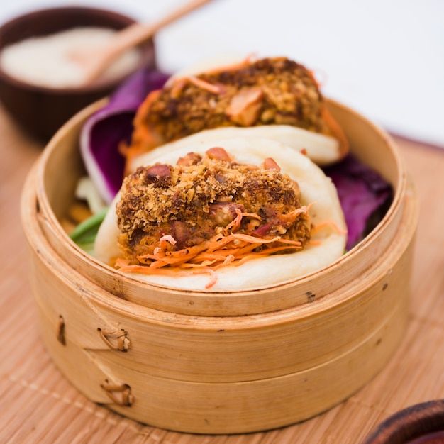 Close-up of traditional food gua bao in bamboo steamer