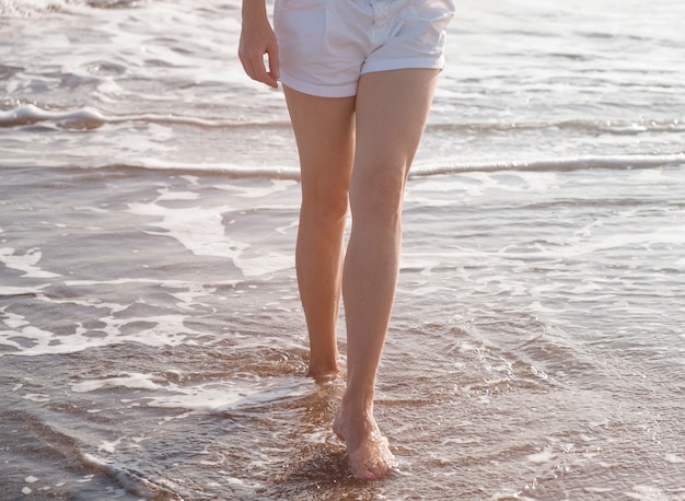 Free photo close up traveler walking in sea