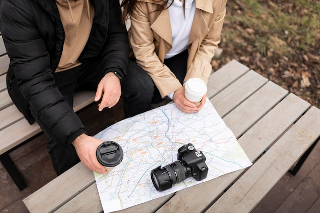 Free photo close up travelers with coffee cups