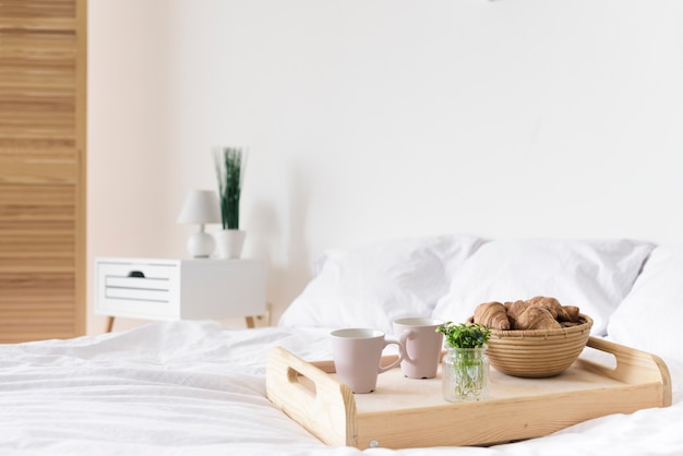 Close-up tray with breakfast on bed