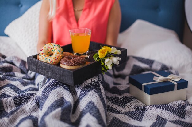 Close-up of tray with donuts and orange juice