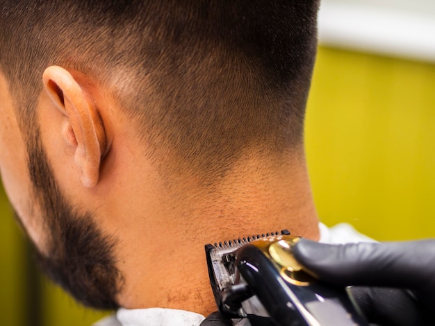 Close-up of trimmer on the back of customer head