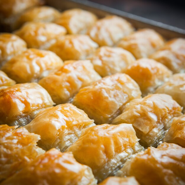 Close-up turkish baklava dessert made of thin pastry, nuts and honey