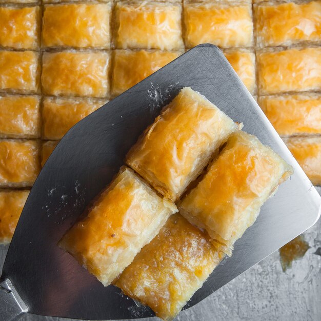 Close-up turkish baklava dessert made of thin pastry, nuts and honey