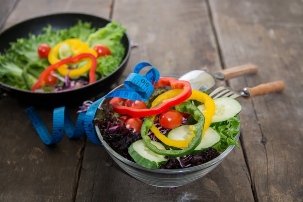 Close-up of two bowls with salad on the wooden table