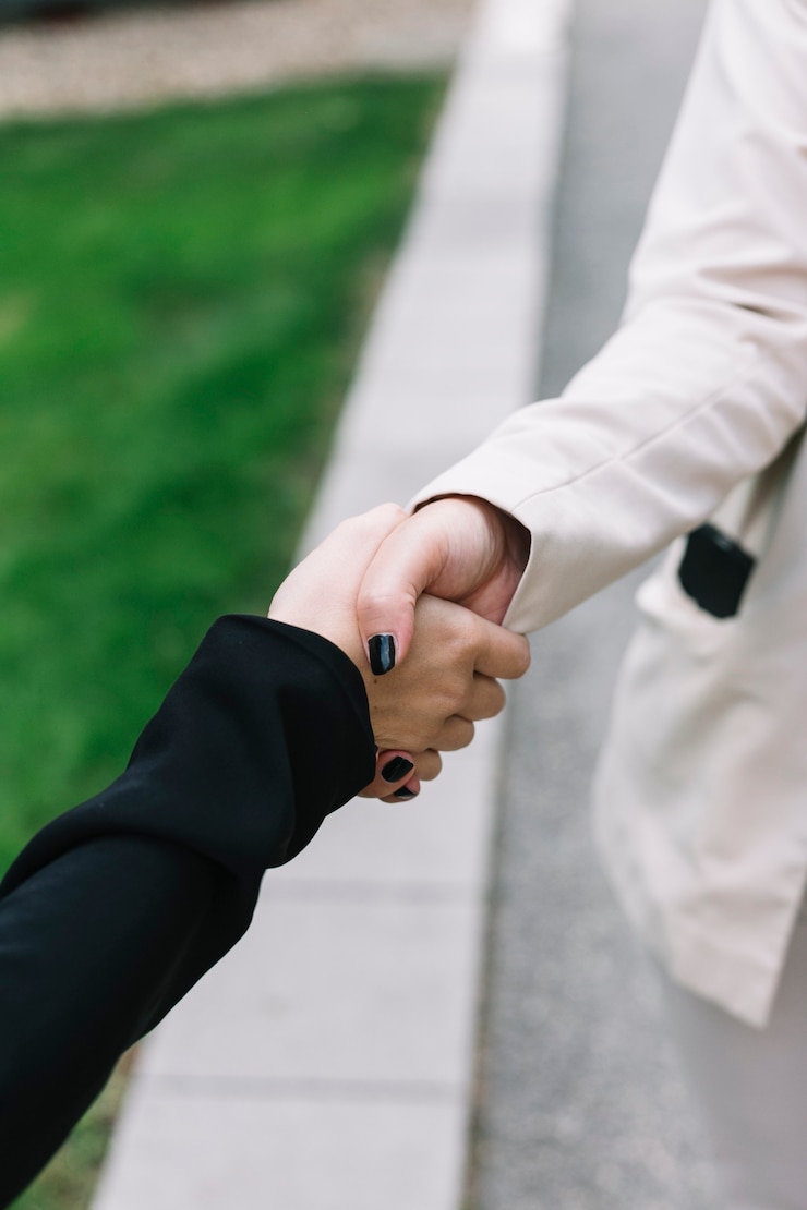 Free Photo close-up of two businesswomen shaking hands