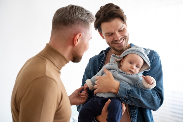 Close up on two dads and a baby