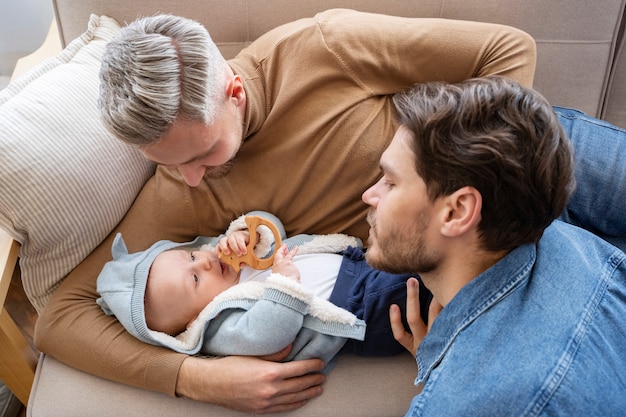 Close up on two dads and a baby