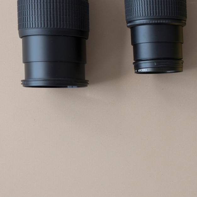 Close-up of two different professional camera on brown background