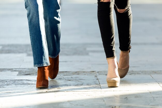 Close-up of two women walking in the street.