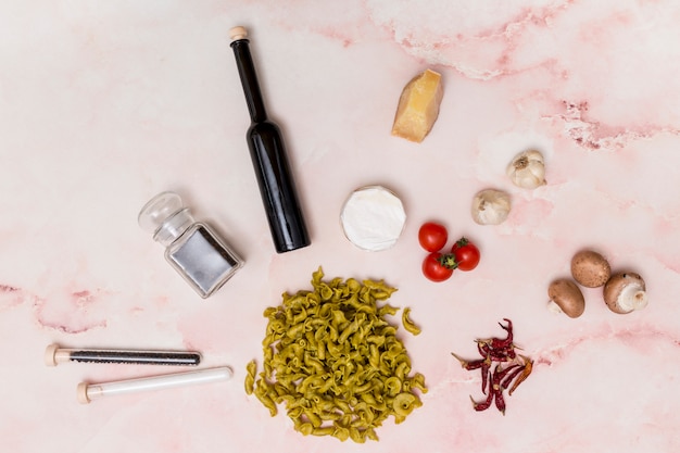 Close-up of uncooked italian pasta surrounded by various ingredients