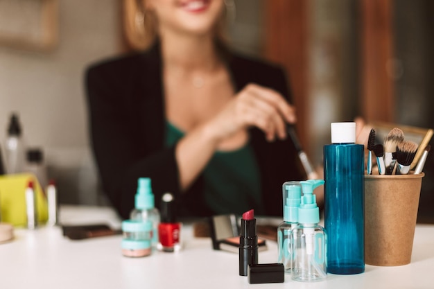 Close up variety of cosmetic products on desk isolated