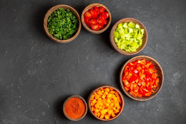 Close up on various chopped vegetables in bowls