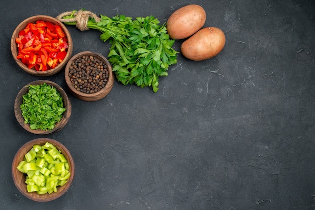 Close up on various chopped vegetables in bowls