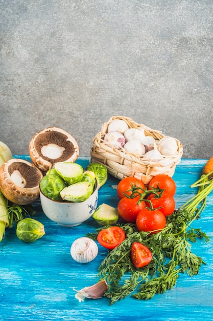 Close-up of various fresh vegetables on blue wooden table