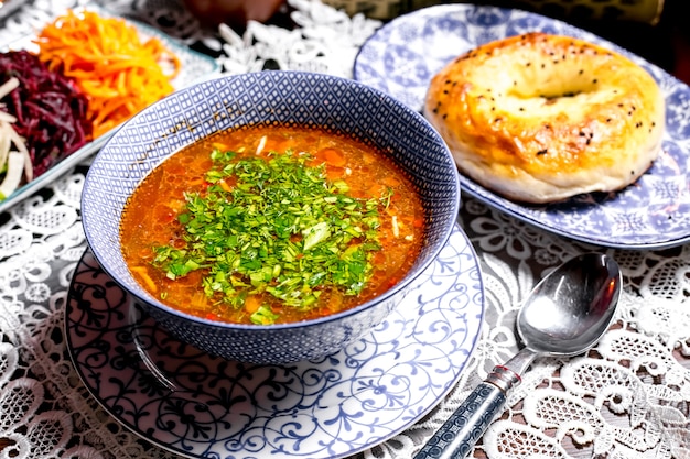 Close up of vegetable soup bowl garnished with herbs