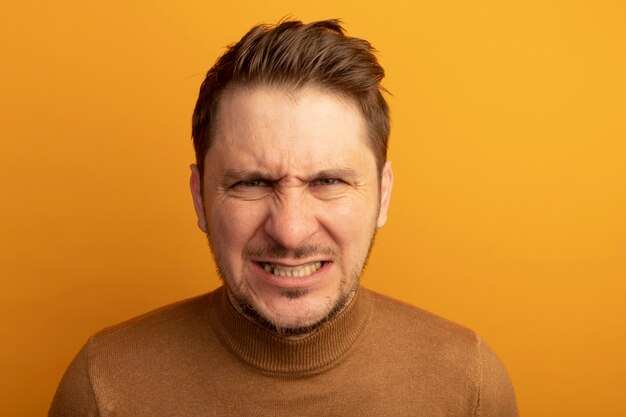 Close-up view of aggressive young blonde handsome man 