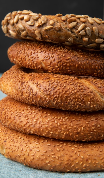 Close-up view of bagels on blue surface and black background