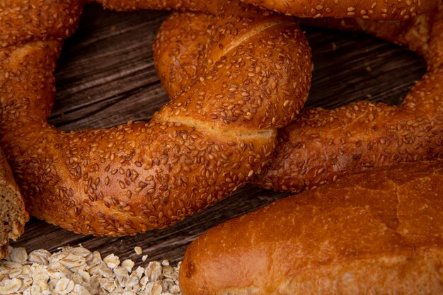 Close-up view of bagels with oat-flakes on wooden background