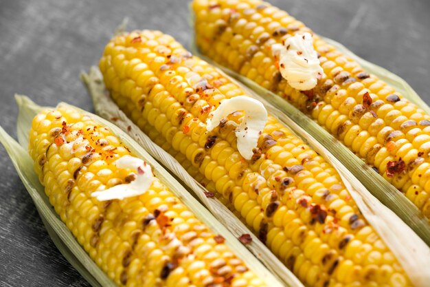 Free photo close-up view of baked corn with butter