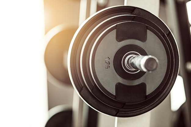 Close up view of barbell on floor in gym