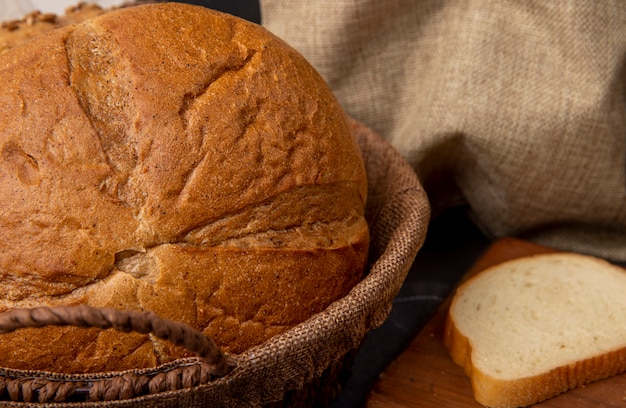 Close-up view of basket with classic cob bread with white bread slice